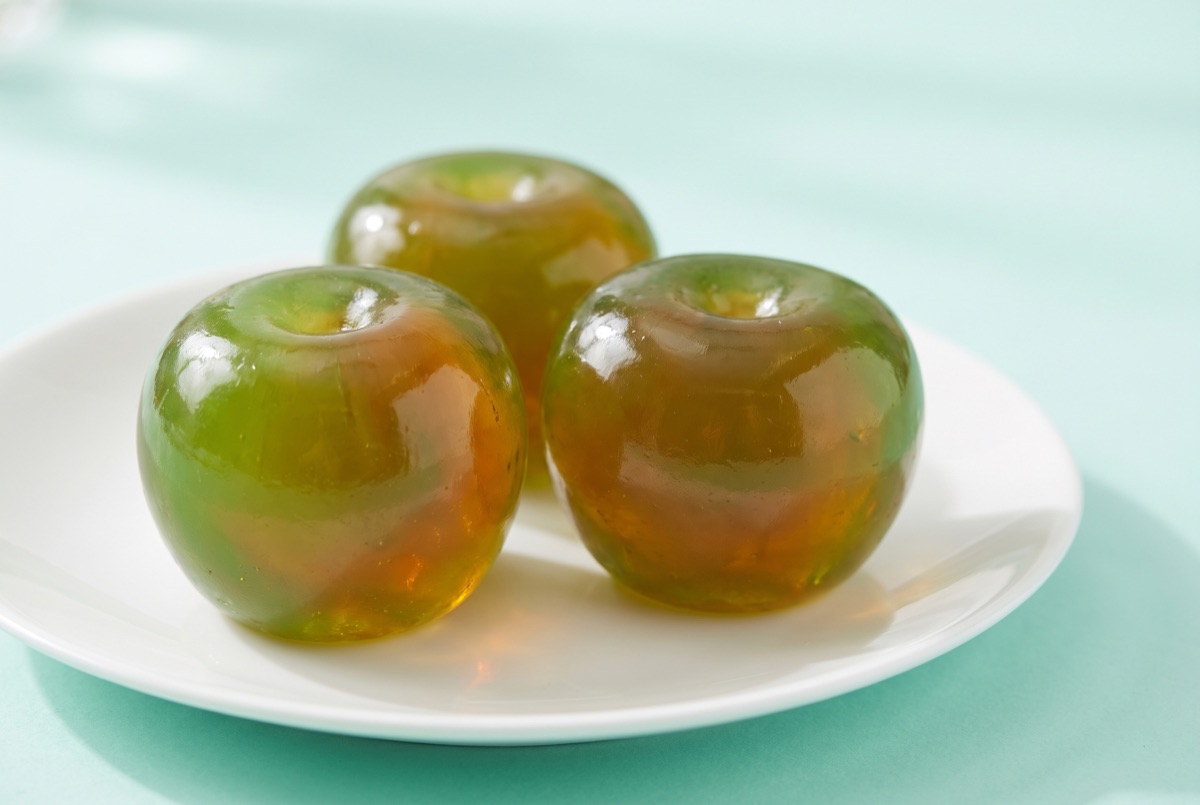 Translucent green apple shaped jelly soaps with a glossy surface
